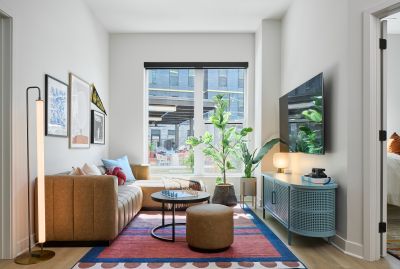 EVER West Lafayette student apartment living room with large L-shaped couch and large screen TV